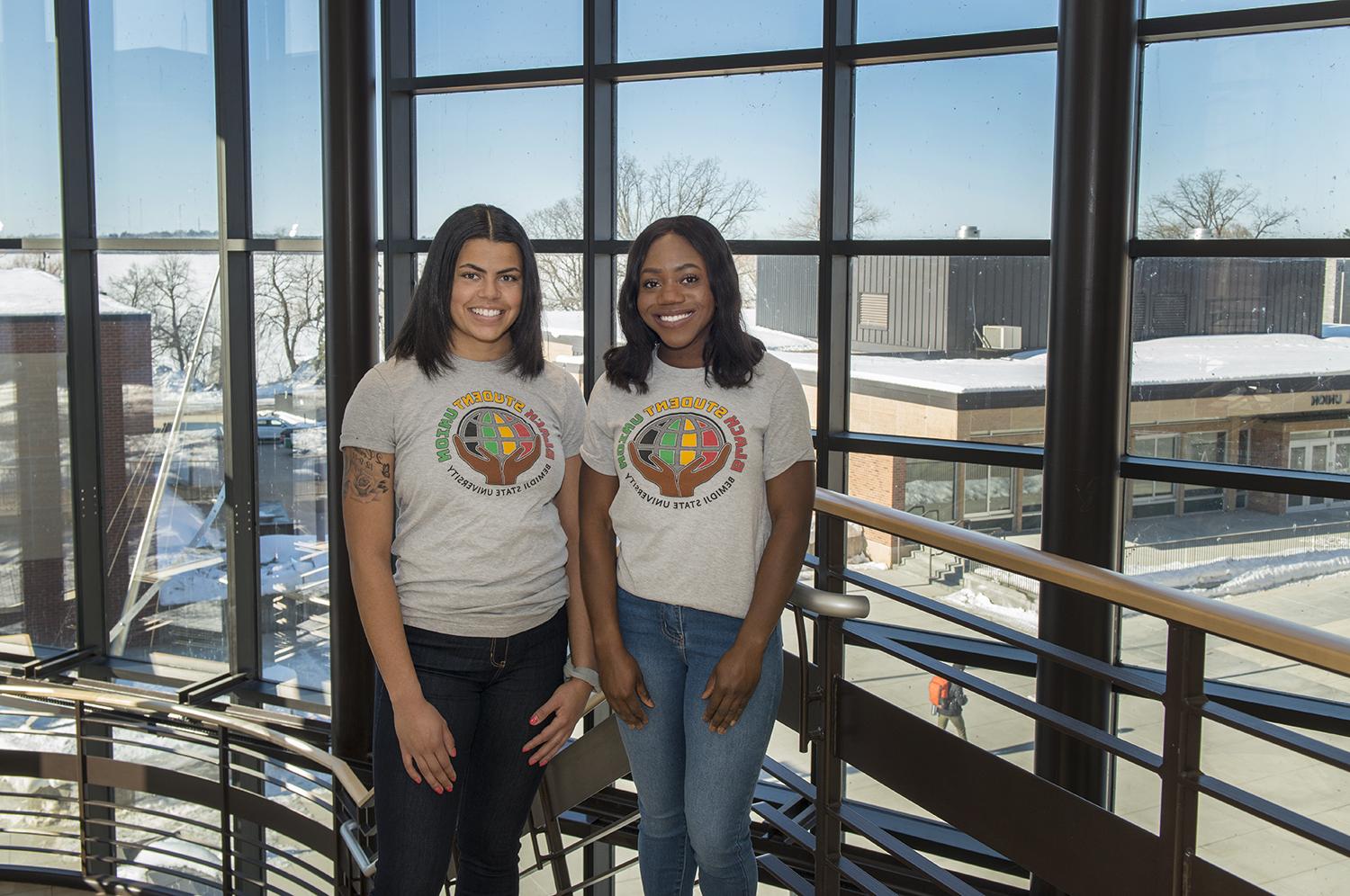 Two students wearing Black Student Union shirts